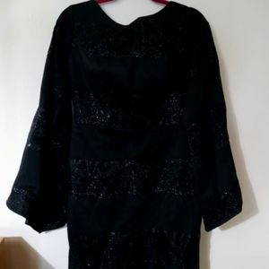 Black dress with silver thread designs.